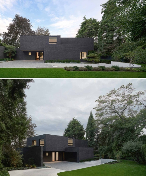 A Dark Brick Exterior For A Home Surrounded By Trees