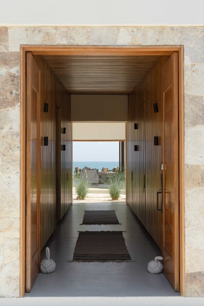 A Stone Covered Home That Surrounds A Central Courtyard With Sunken Seating