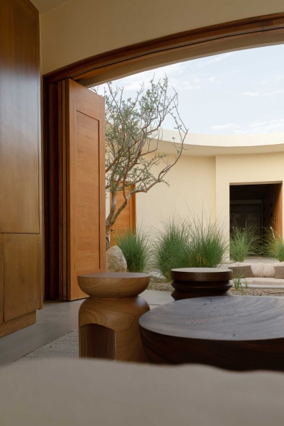 A Stone Covered Home That Surrounds A Central Courtyard With Sunken Seating