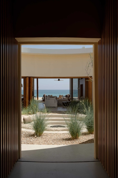 A Stone Covered Home That Surrounds A Central Courtyard With Sunken Seating