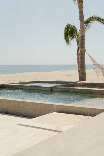 A Stone Covered Home That Surrounds A Central Courtyard With Sunken Seating