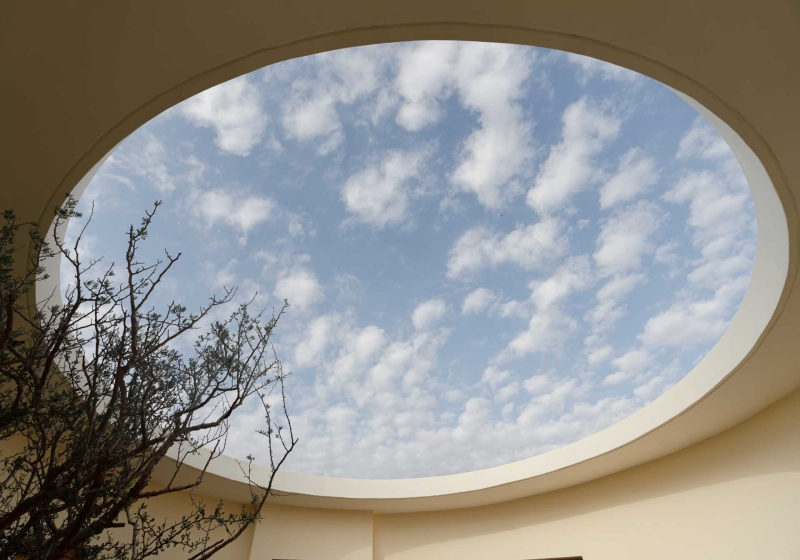 A Stone Covered Home That Surrounds A Central Courtyard With Sunken Seating