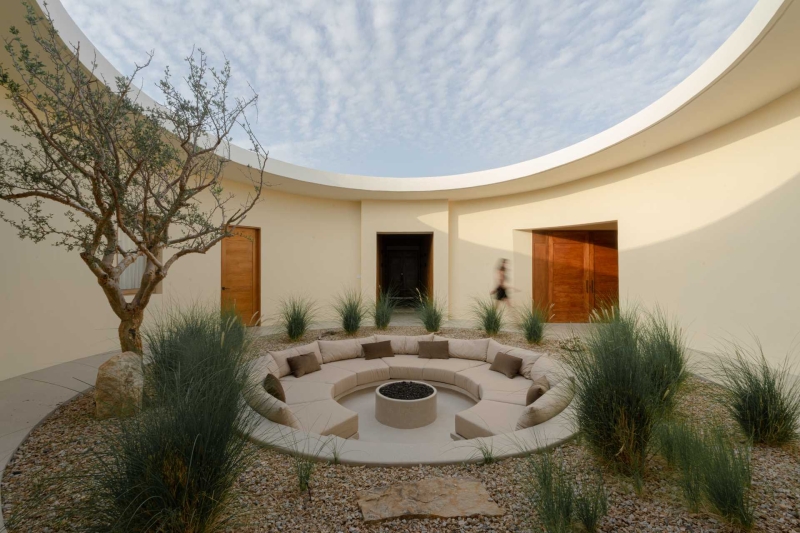 A Stone Covered Home That Surrounds A Central Courtyard With Sunken Seating