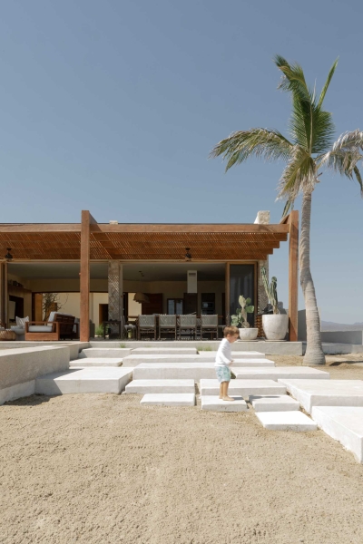 A Stone Covered Home That Surrounds A Central Courtyard With Sunken Seating