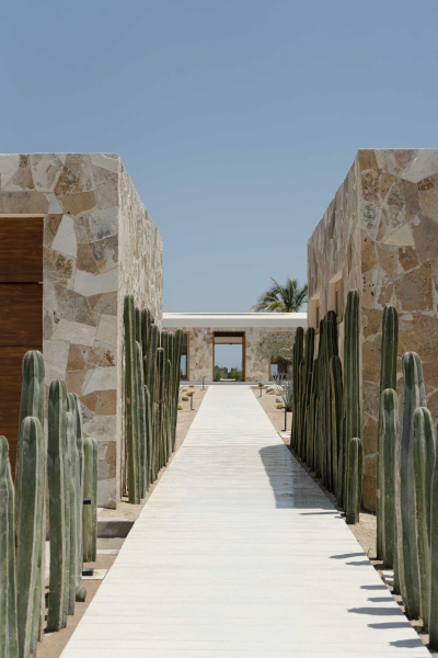 A Stone Covered Home That Surrounds A Central Courtyard With Sunken Seating