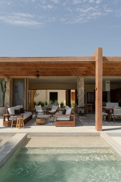 A Stone Covered Home That Surrounds A Central Courtyard With Sunken Seating