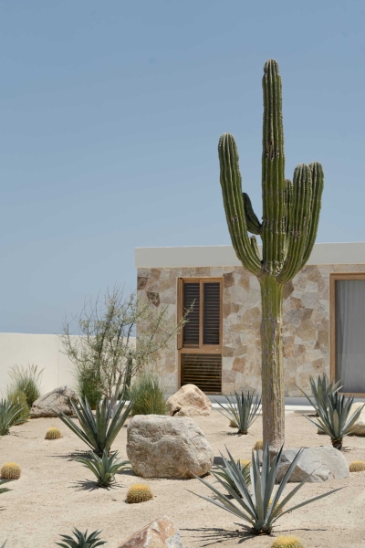 A Stone Covered Home That Surrounds A Central Courtyard With Sunken Seating