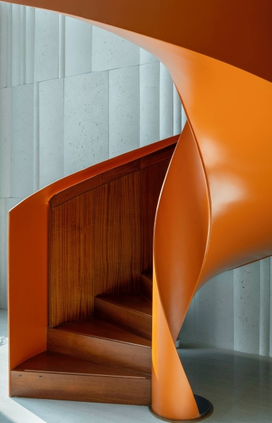 An Orange Spiral Staircase Is An Eye-Catching Feature Inside This Apartment