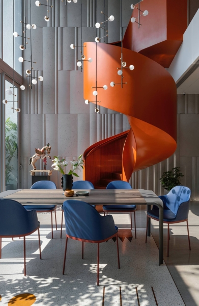 An Orange Spiral Staircase Is An Eye-Catching Feature Inside This Apartment