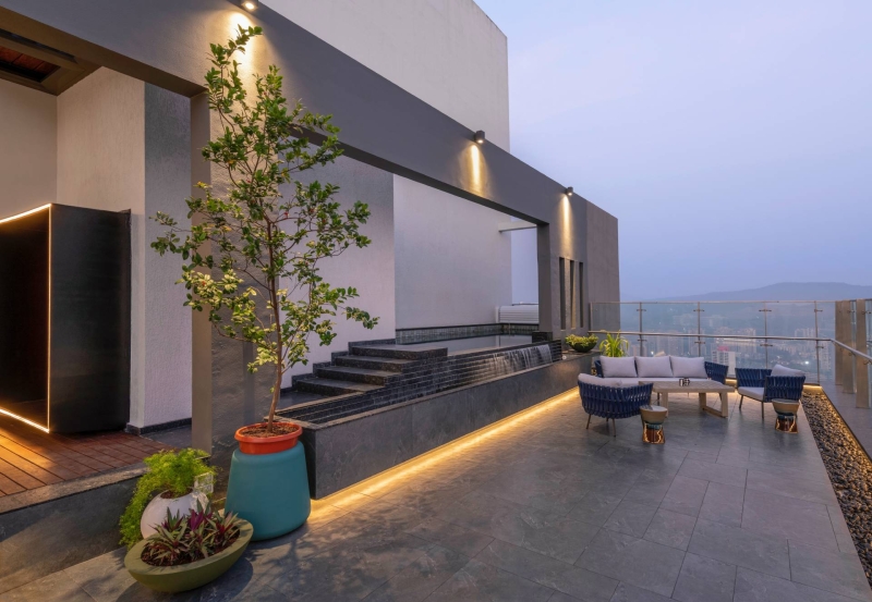 An Orange Spiral Staircase Is An Eye-Catching Feature Inside This Apartment