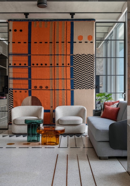 An Orange Spiral Staircase Is An Eye-Catching Feature Inside This Apartment