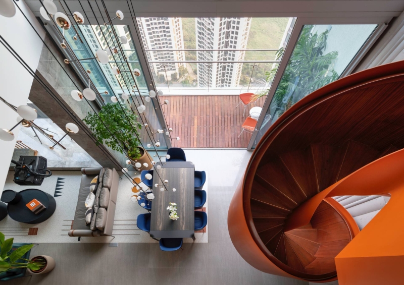 An Orange Spiral Staircase Is An Eye-Catching Feature Inside This Apartment