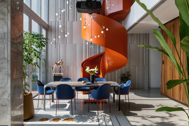 An Orange Spiral Staircase Is An Eye-Catching Feature Inside This Apartment