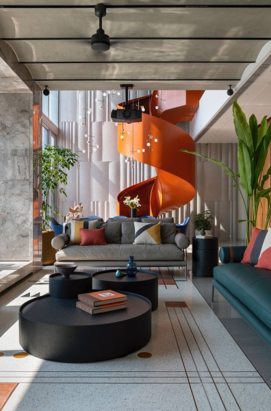 An Orange Spiral Staircase Is An Eye-Catching Feature Inside This Apartment