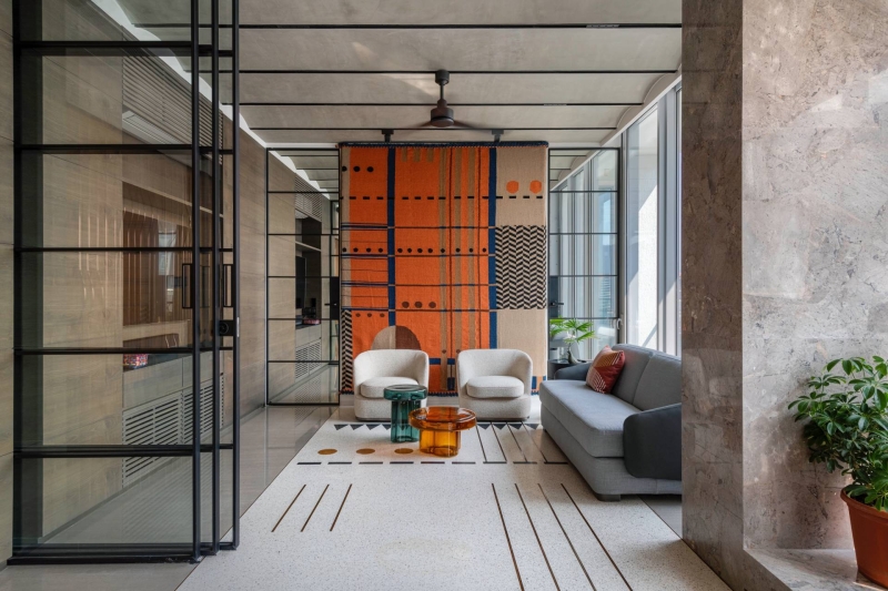 An Orange Spiral Staircase Is An Eye-Catching Feature Inside This Apartment