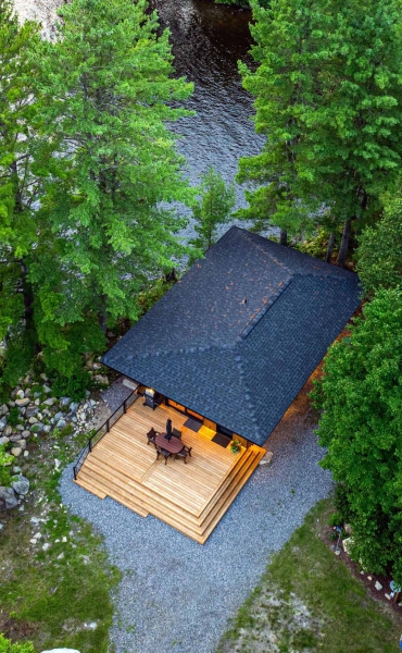 Exposed Wood Posts & Beams Add A Warm Rustic Touch To This Small Cabin