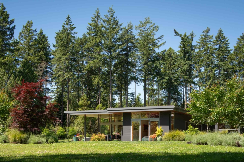 Modern meets nature in this home that opens to a meadow in the trees