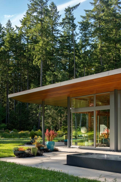 Modern meets nature in this home that opens to a meadow in the trees