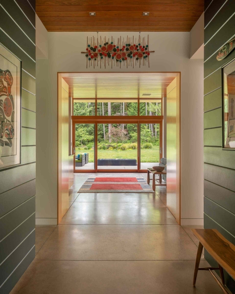 Modern meets nature in this home that opens to a meadow in the trees