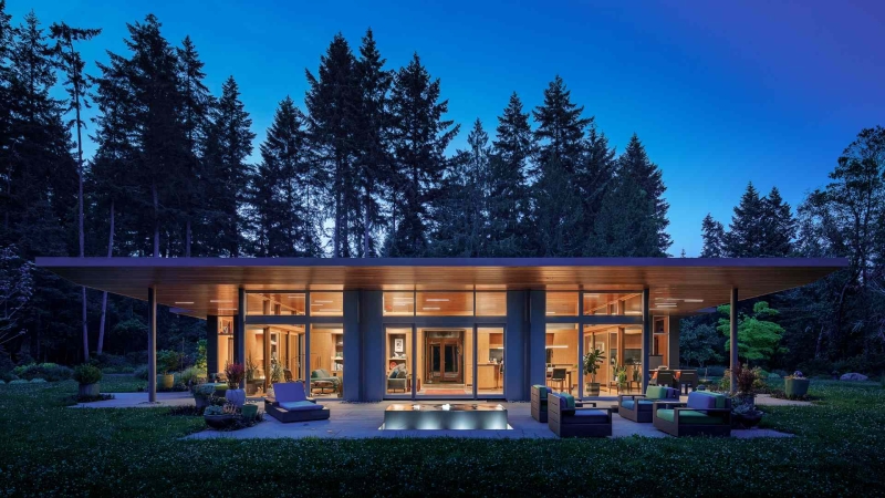 Modern meets nature in this home that opens to a meadow in the trees