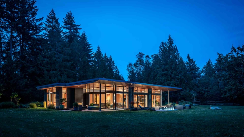 Modern meets nature in this home that opens to a meadow in the trees