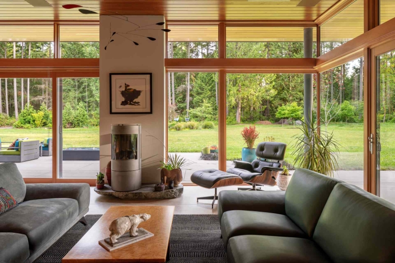 Modern meets nature in this home that opens to a meadow in the trees