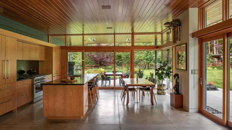 Modern meets nature in this home that opens to a meadow in the trees