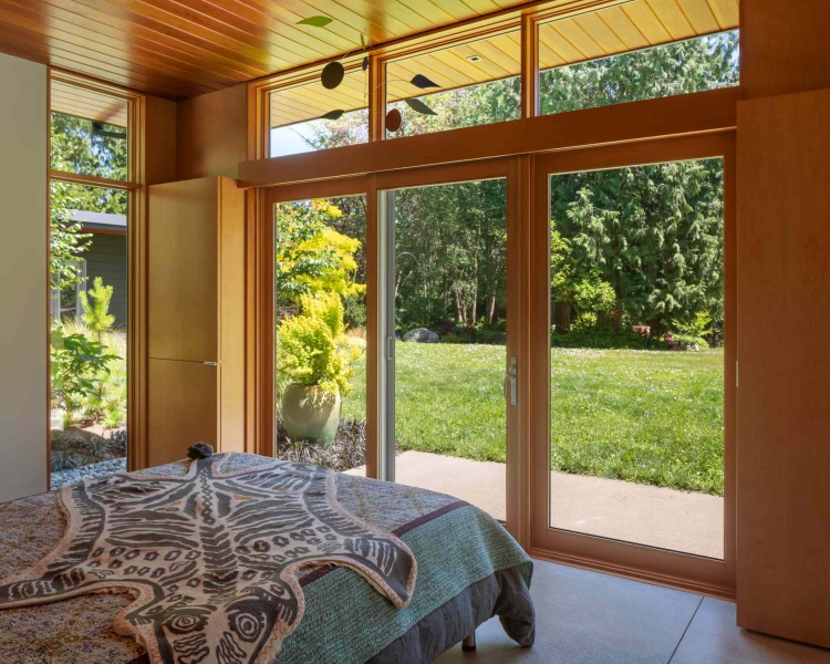 Modern meets nature in this home that opens to a meadow in the trees