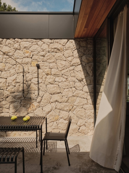 A Seaside Home Where Limestone, Wood, and Glass Unite