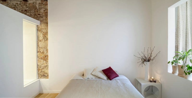 A Rustic Stone Wall Meets Sleek Minimalism in This Apartment