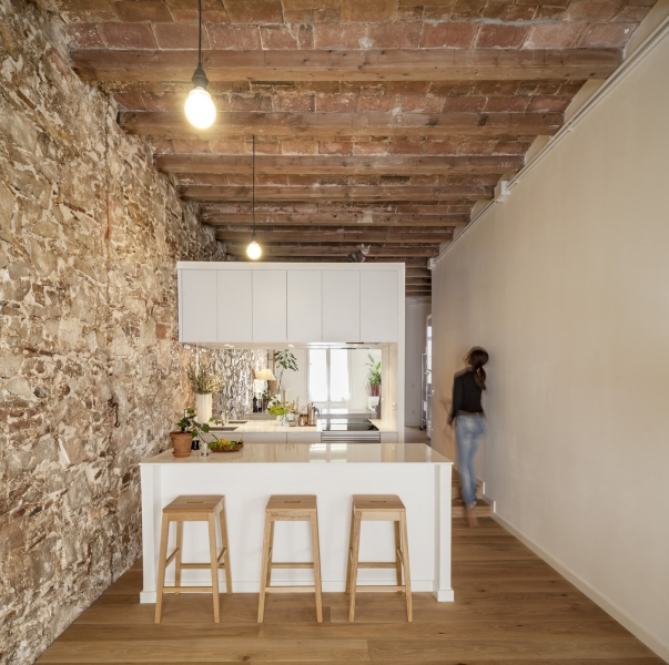 A Rustic Stone Wall Meets Sleek Minimalism in This Apartment