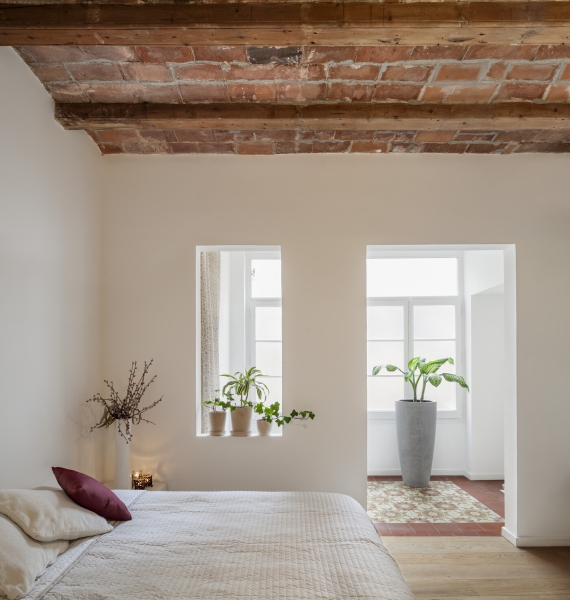 A Rustic Stone Wall Meets Sleek Minimalism in This Apartment