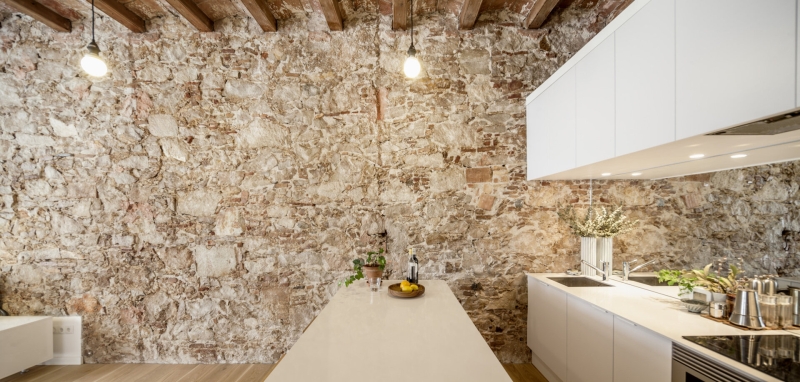 A Rustic Stone Wall Meets Sleek Minimalism in This Apartment