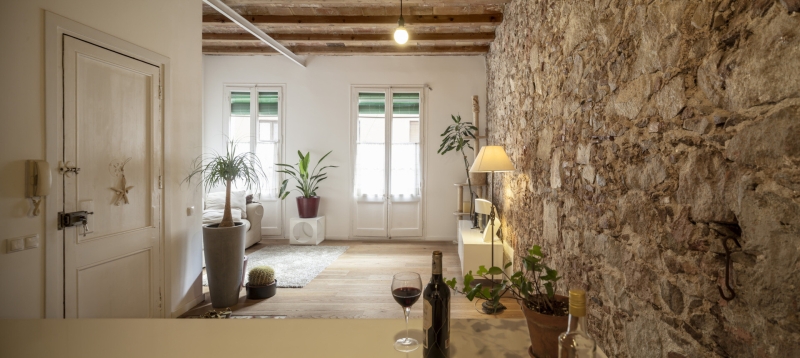 A Rustic Stone Wall Meets Sleek Minimalism in This Apartment