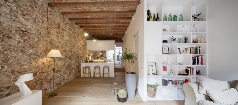 A Rustic Stone Wall Meets Sleek Minimalism in This Apartment