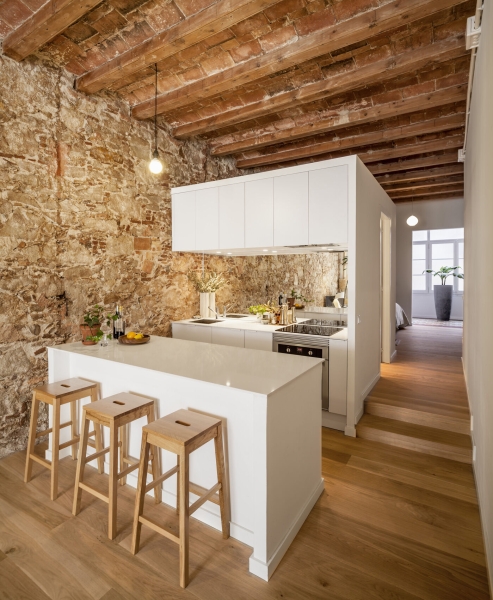 A Rustic Stone Wall Meets Sleek Minimalism in This Apartment
