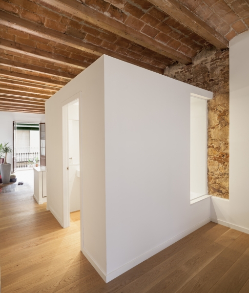 A Rustic Stone Wall Meets Sleek Minimalism in This Apartment