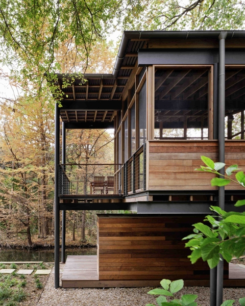 Floating over a creek, this elevated hideaway turns the forest into a living room