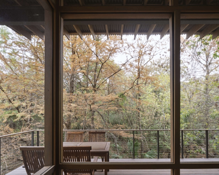 Floating over a creek, this elevated hideaway turns the forest into a living room