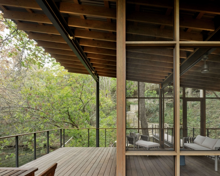 Floating over a creek, this elevated hideaway turns the forest into a living room