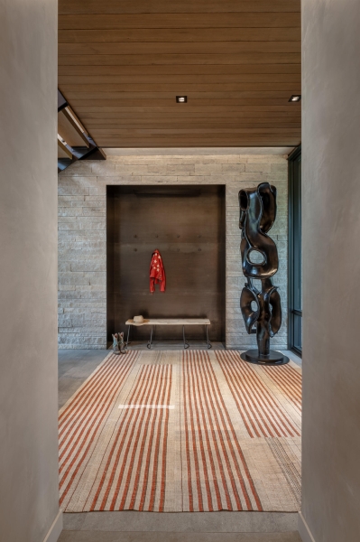 From the outside this home is all blackened wood, but inside it glows with warmth