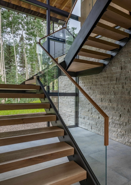 From the outside this home is all blackened wood, but inside it glows with warmth
