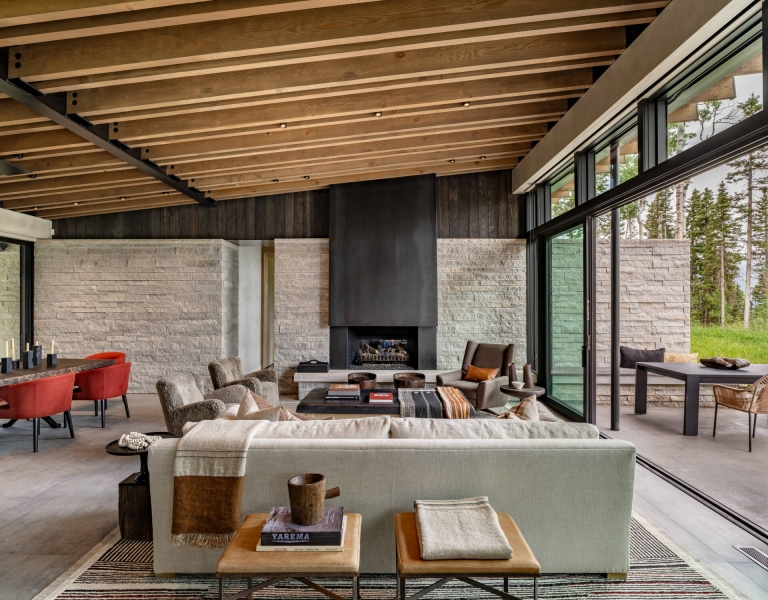 From the outside this home is all blackened wood, but inside it glows with warmth