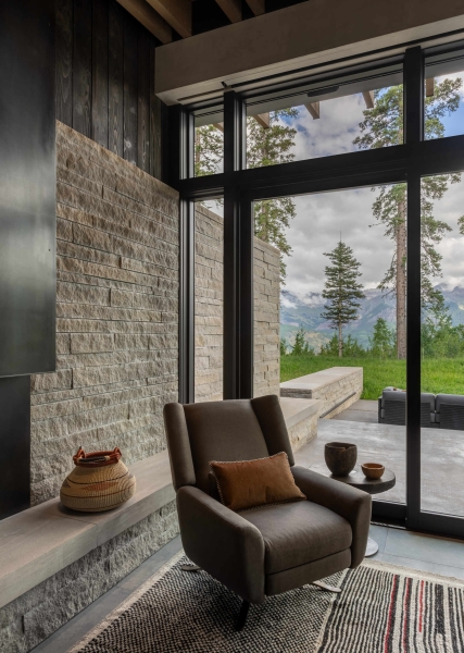 From the outside this home is all blackened wood, but inside it glows with warmth