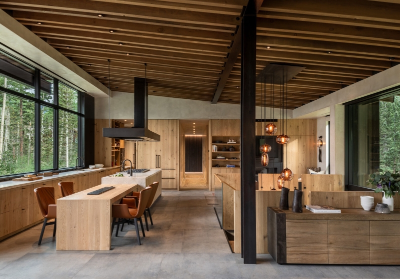 From the outside this home is all blackened wood, but inside it glows with warmth