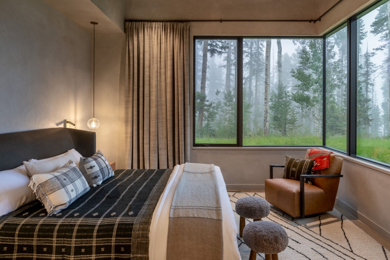 From the outside this home is all blackened wood, but inside it glows with warmth
