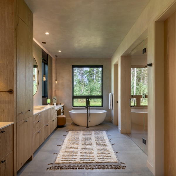 From the outside this home is all blackened wood, but inside it glows with warmth