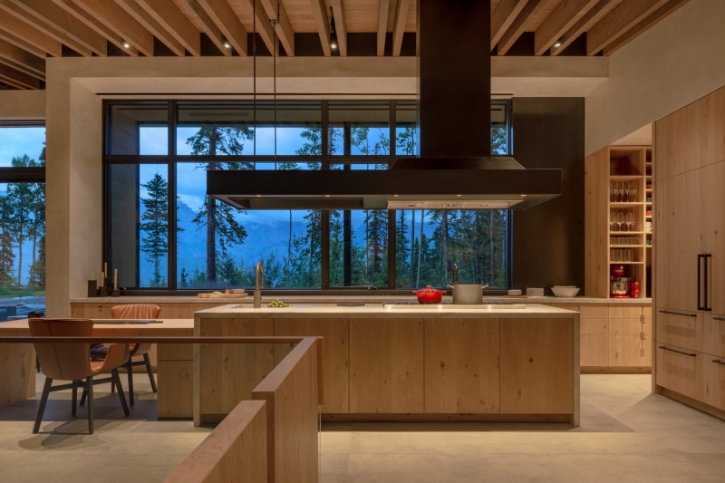 From the outside this home is all blackened wood, but inside it glows with warmth