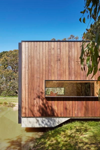 A slow living cabin where fold-out walls transform the space from studio to home