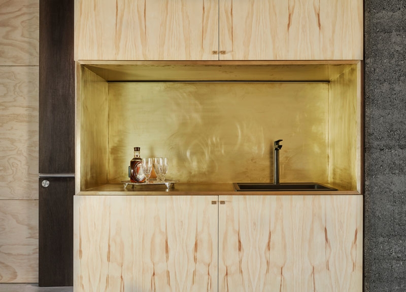 A slow living cabin where fold-out walls transform the space from studio to home